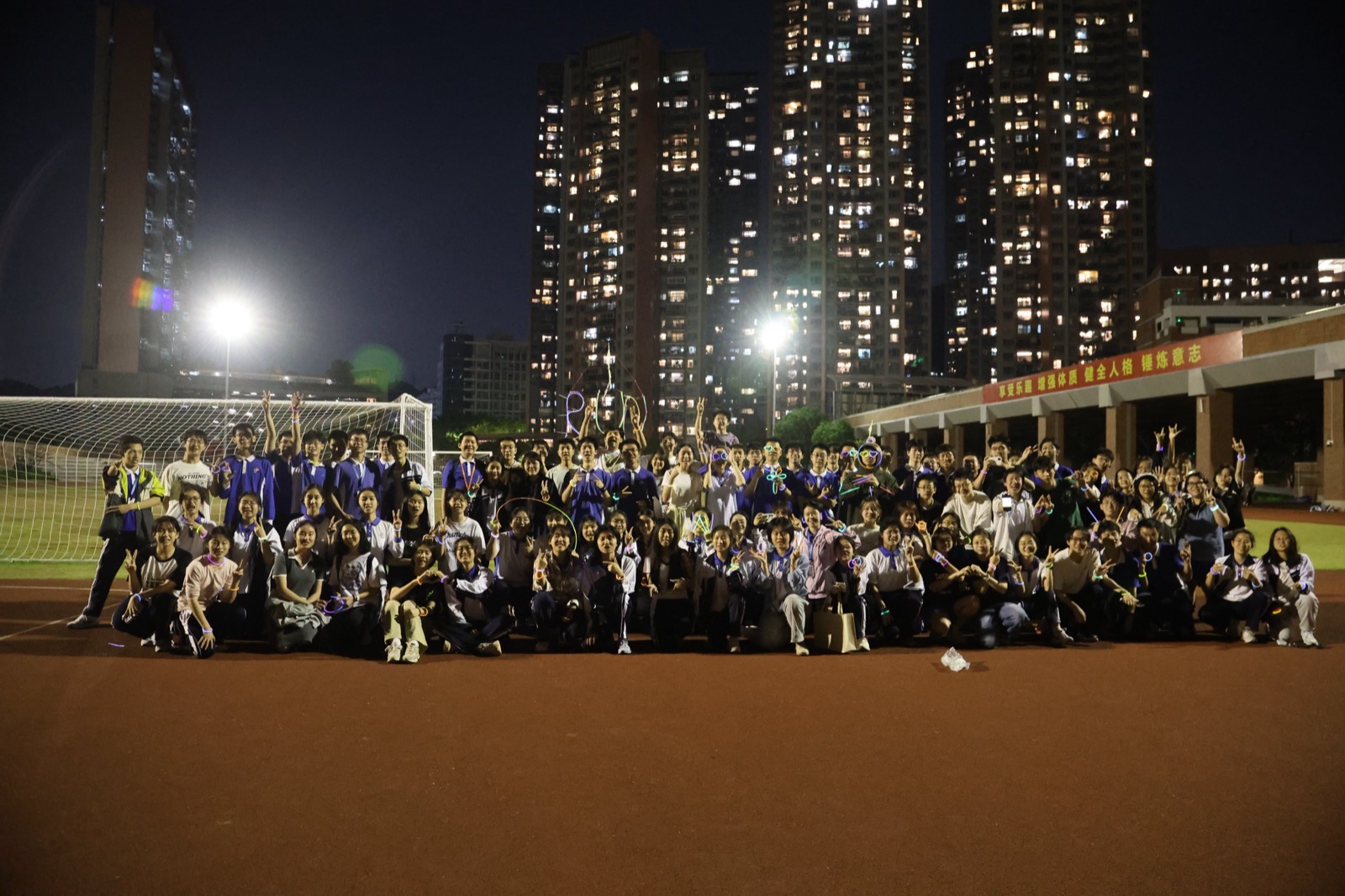 A large running club group at night